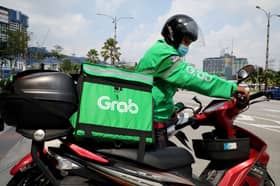 SoftBank-backed ride-hailing firm Grab cuts staff to cope with virus impact