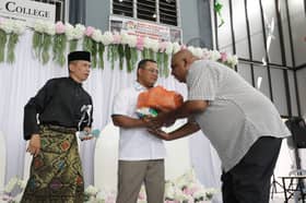 MB hands contributions to less fortunate students