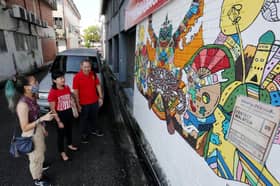 Muralist livens up faded wall paintings in SS2
