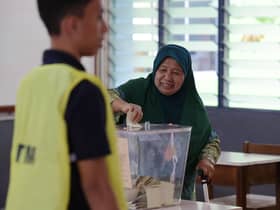 Johor voters working in Singapore brave downpour to cast ballots