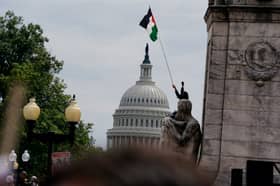 Protesters hoist Palestine flags in Washington during Netanyahu speech