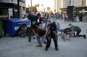 Riot police, anti-ICE protesters square off in Los Angeles after raids