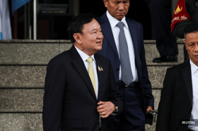 Former Thai PM Thaksin leaves country amid turmoil