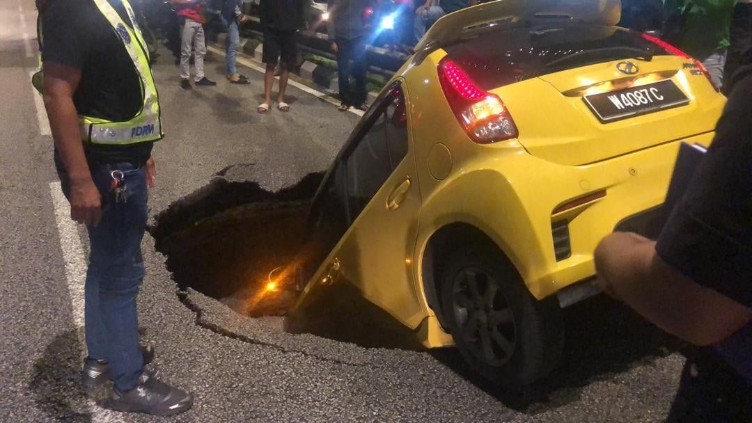 Car falls into sinkhole in KL, driver unhurt