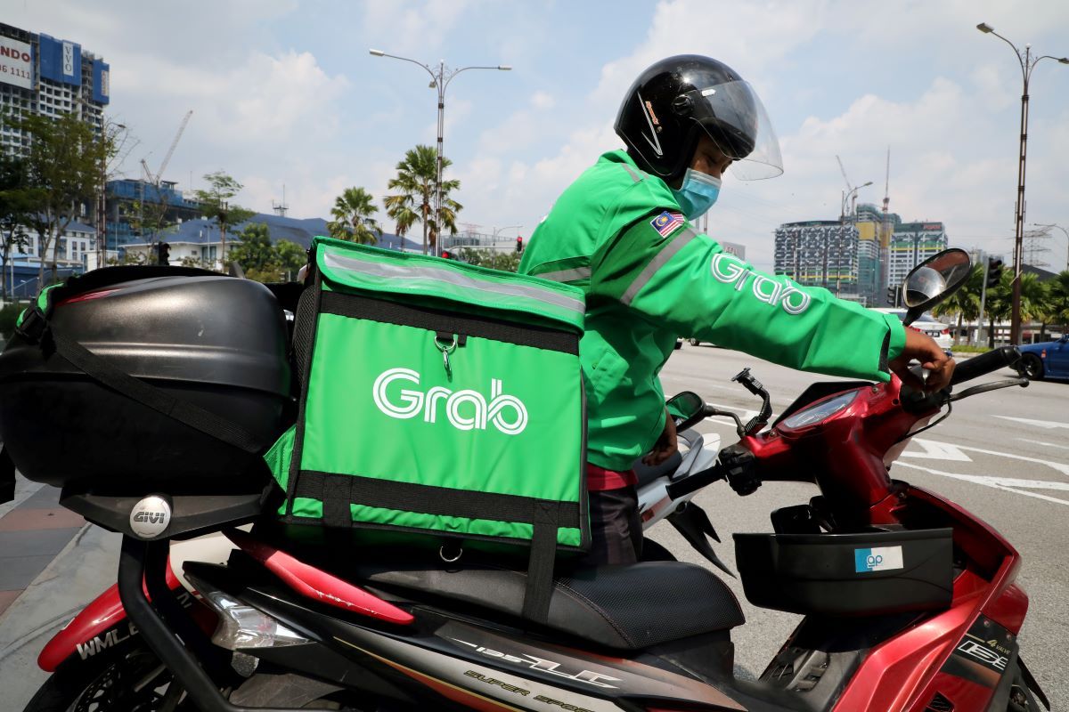 SoftBank-backed ride-hailing firm Grab cuts staff to cope with virus impact