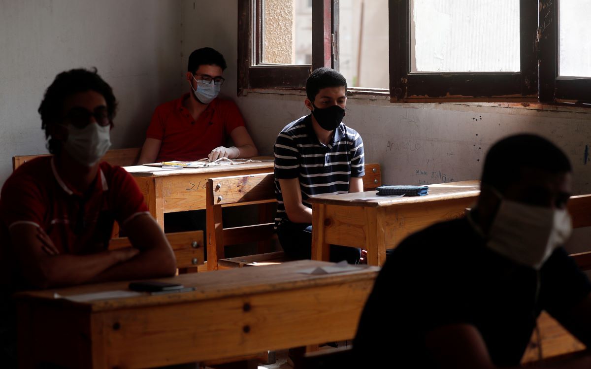 Egyptian high-school pupils, masked and gloved, head into exams