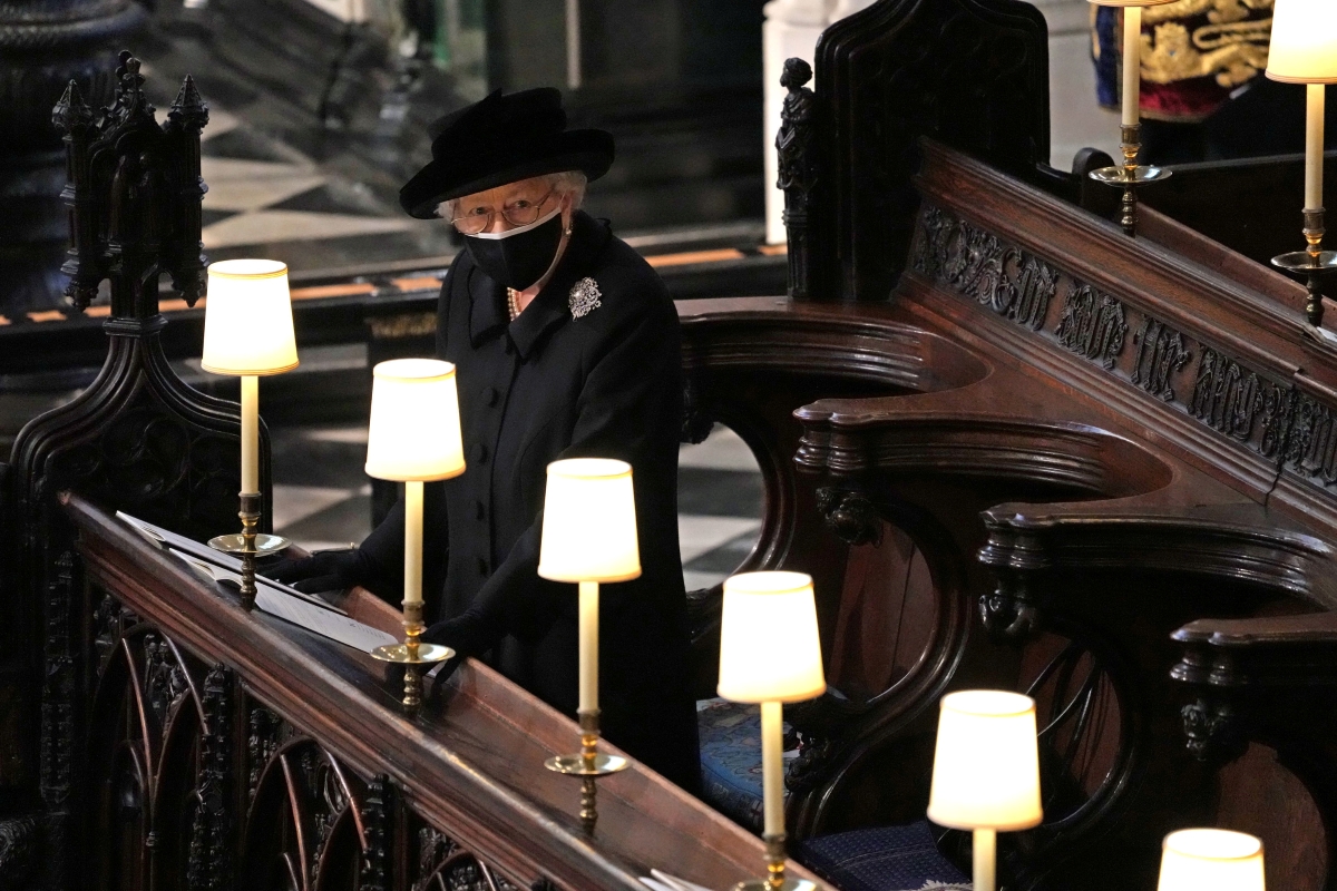 Queen Elizabeth stands alone as Philip is laid to rest