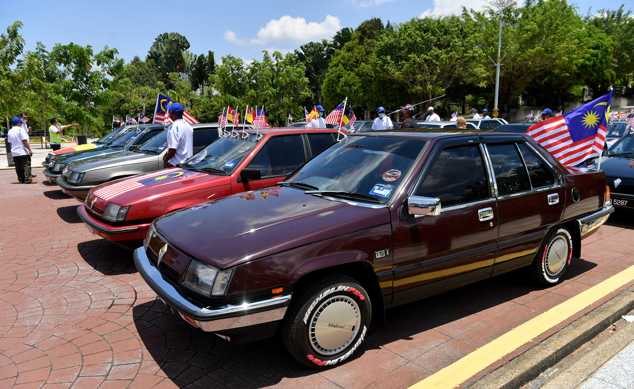 A convoy of classic Proton Saga cars stirs nostalgia on Malaysia Day