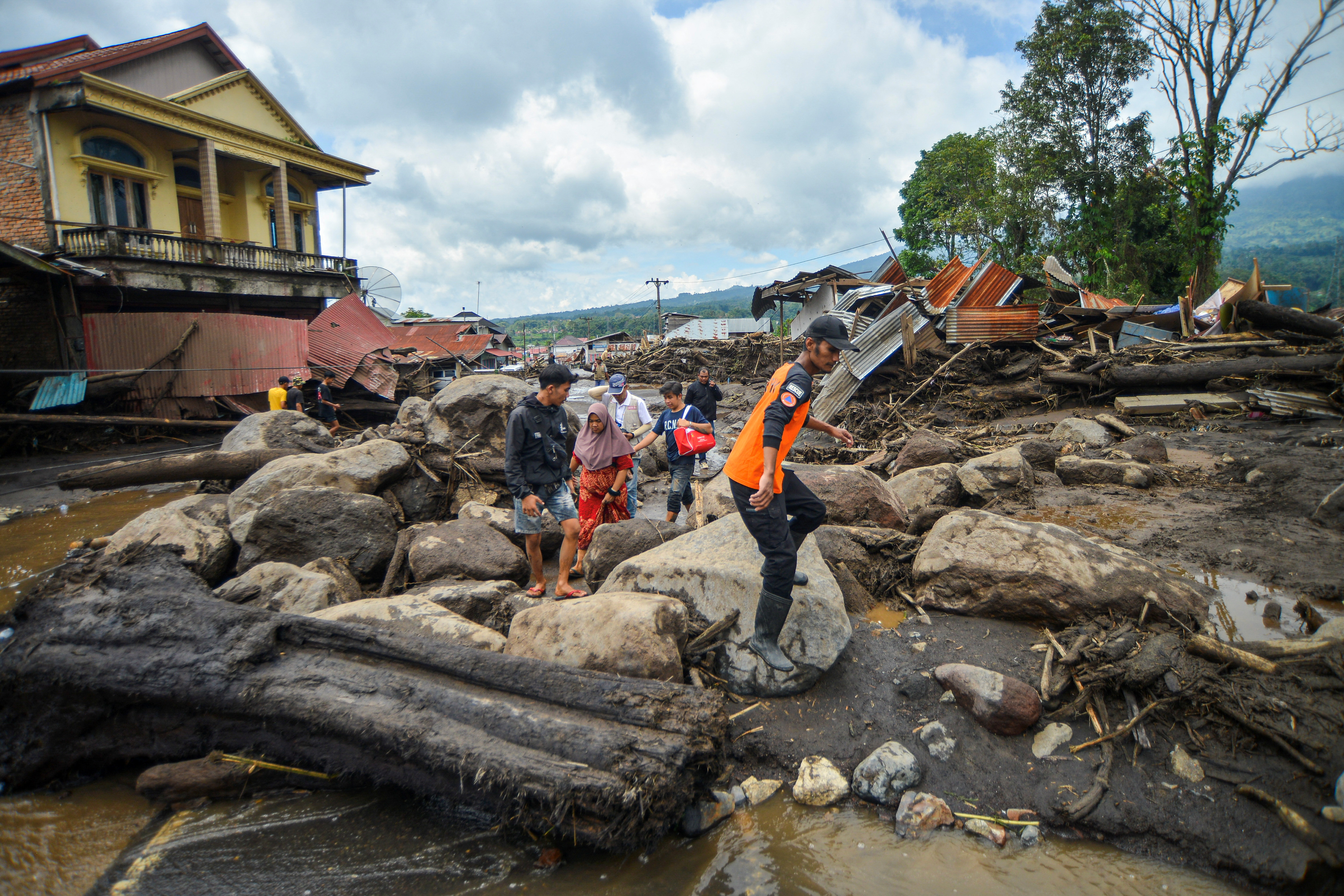 Death toll in Indonesia floods, volcanic mud flows rises to 58