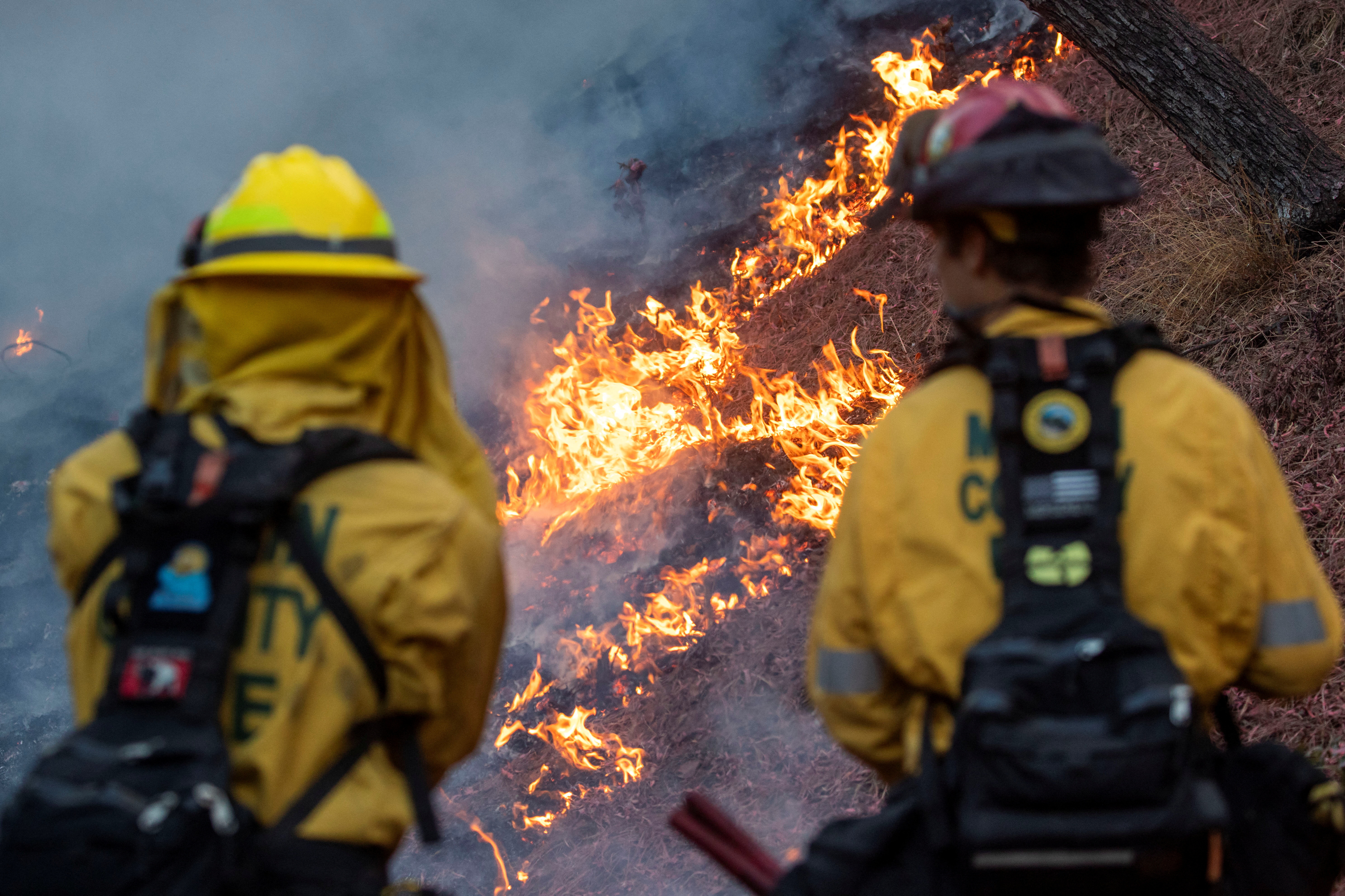 Los Angeles races to contain wildfires before severe weather returns