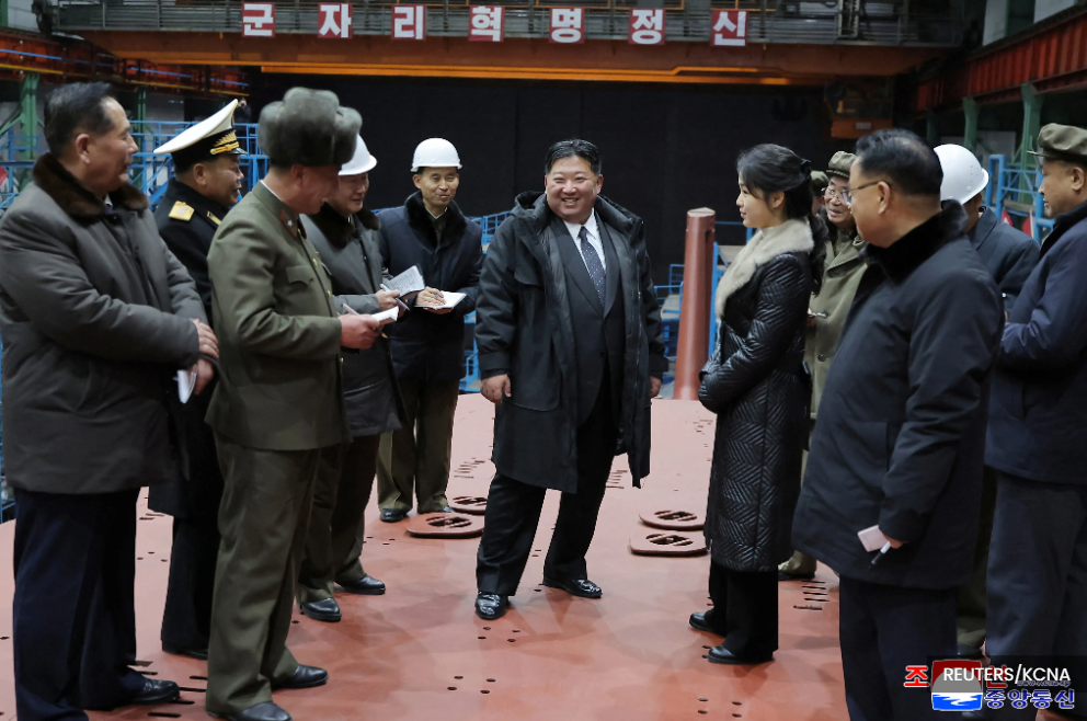 Kim Jong Un views submarine construction, oversees missile launch